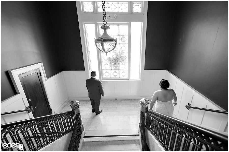 First look on stairs at Glorietta Bay Inn from wedding in Coronado, CA.