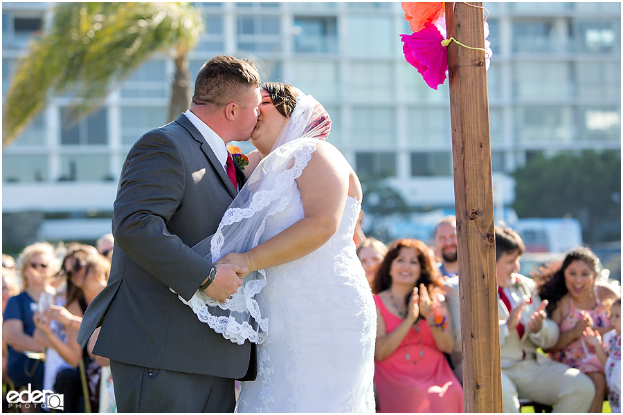 Bride and groom first kiss at Coronado Community Center wedding. 
