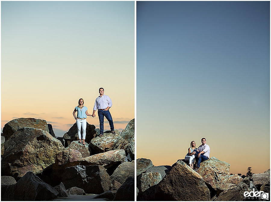 Couple on rocks in front of the Hotel Del Coronado during engagement session. 