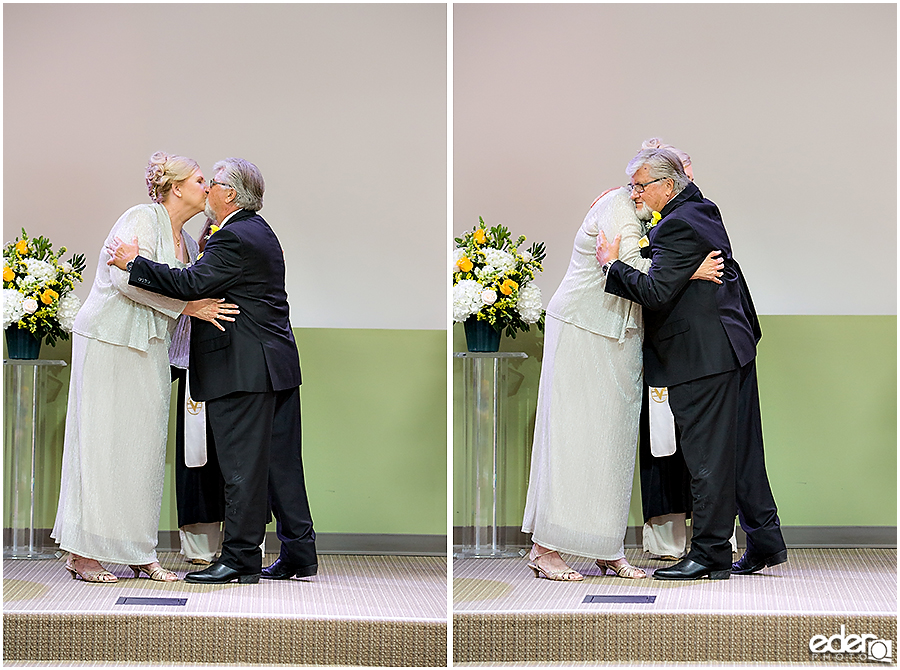 First kiss during small wedding ceremony.