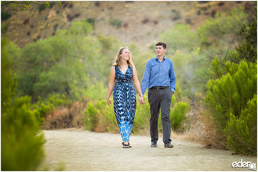 Walking down a trail during an engagement session in Mission Trails Regional Park.