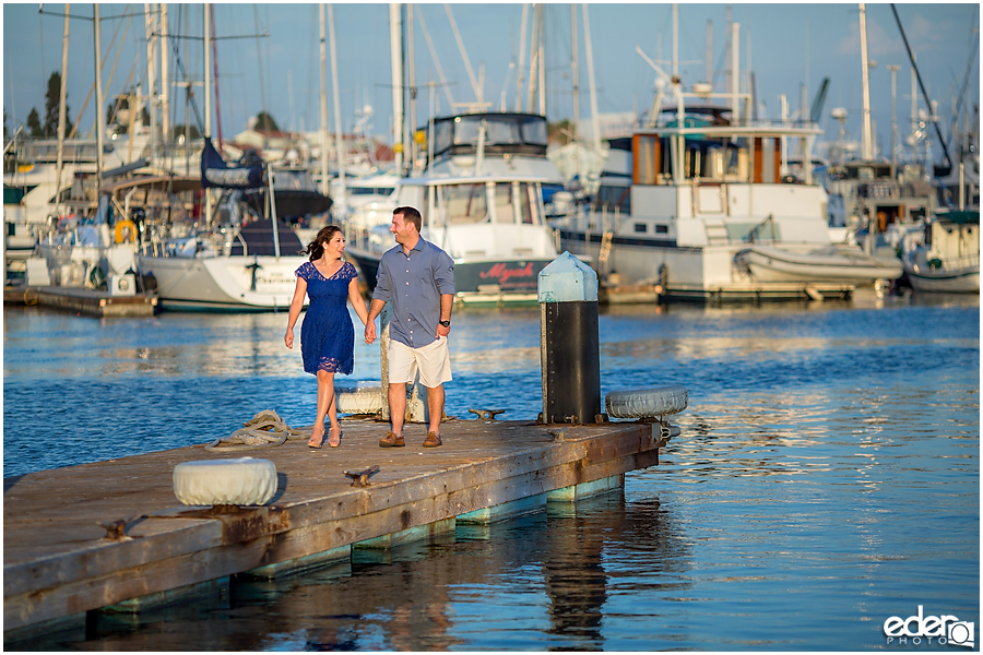 Walking on a dock during a Point Loma engagement session.