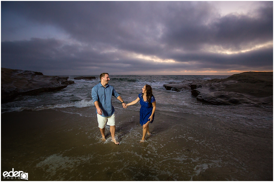 Walking in water San Diego Sunset Cliffs engagement session.