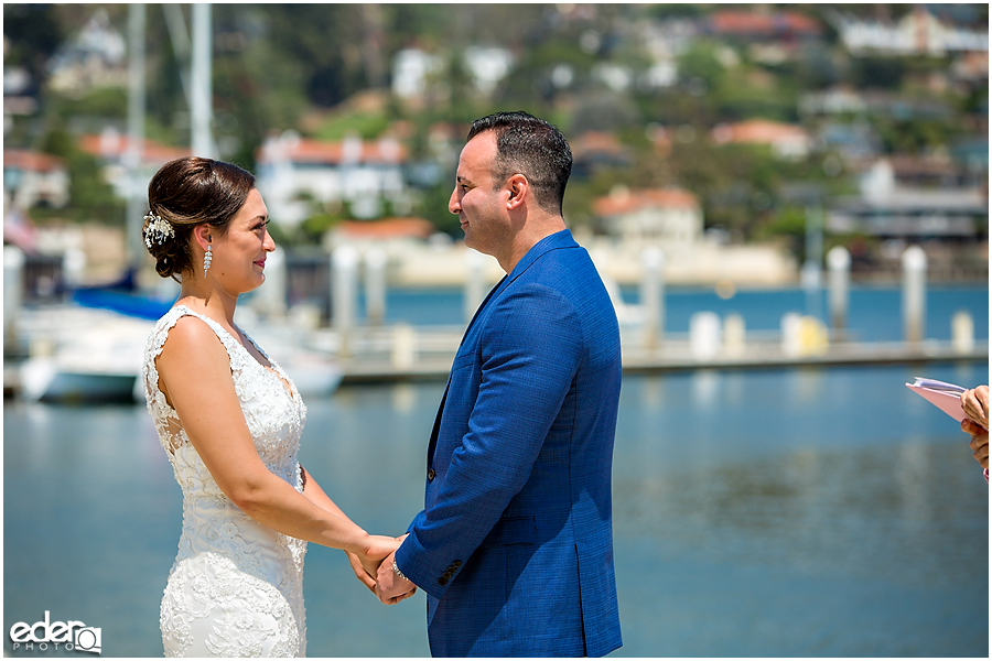 Couple with water in the background during beach elopement at the Kona Kai Resort in San Diego, CA.