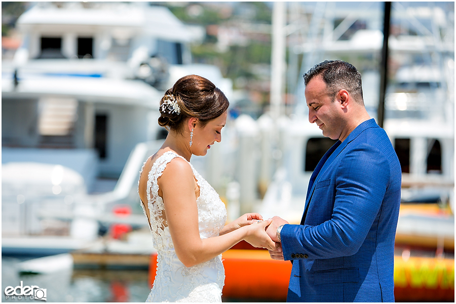 Ring exchange during beach elopement at the Kona Kai Resort in San Diego, CA.