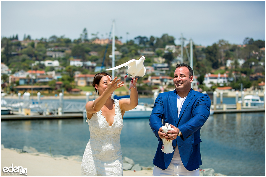 Doves being released during San Diego beach elopement. 