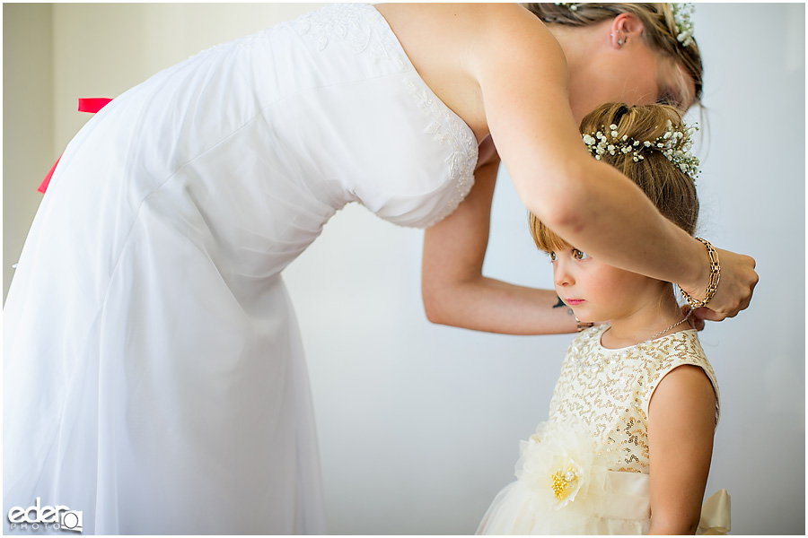 Flower girl receiving jewelry. 