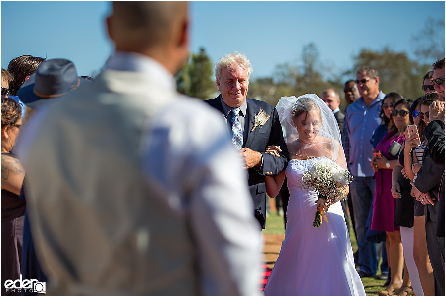 Bride and dad at baseball themed wedding ceremony. 