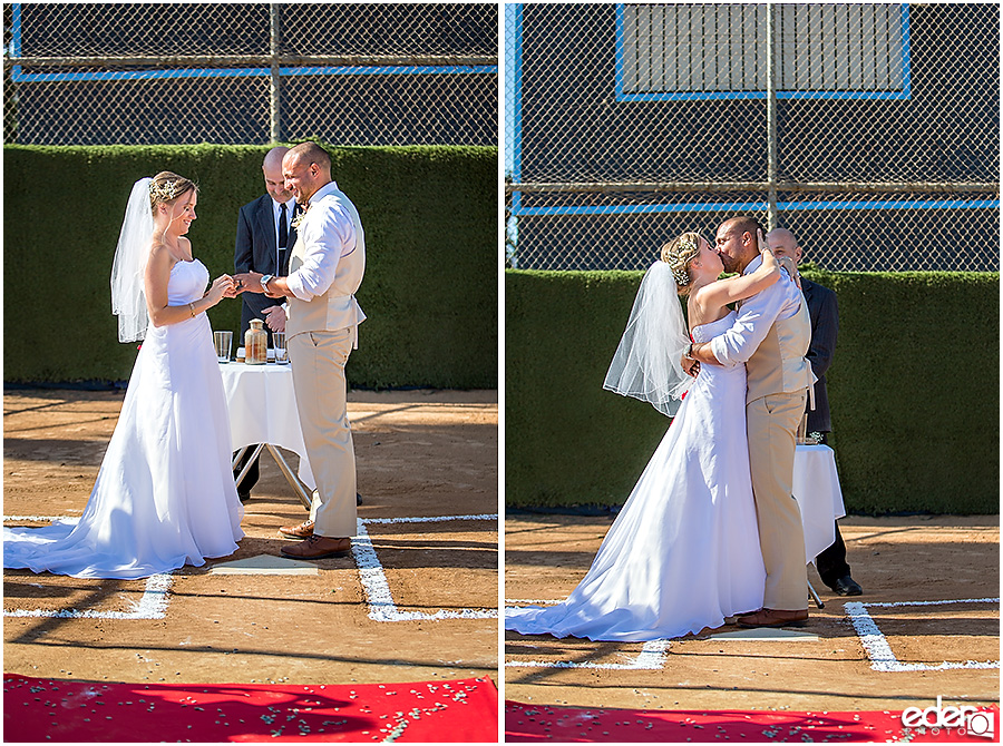 First kiss during baseball themed wedding ceremony. 