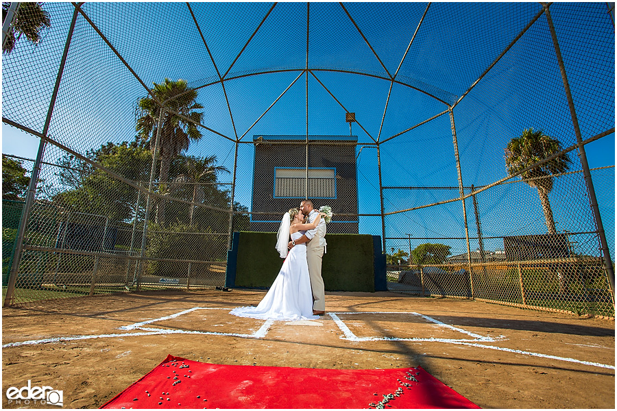 Bride and groom on baseball diamond during baseball themed wedding ceremony. 