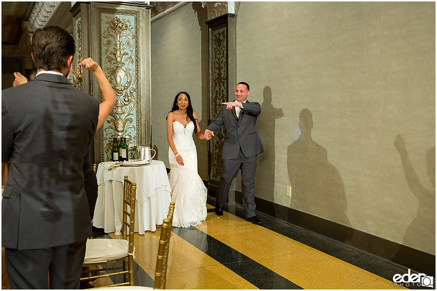 Bride and groom entering wedding reception. 