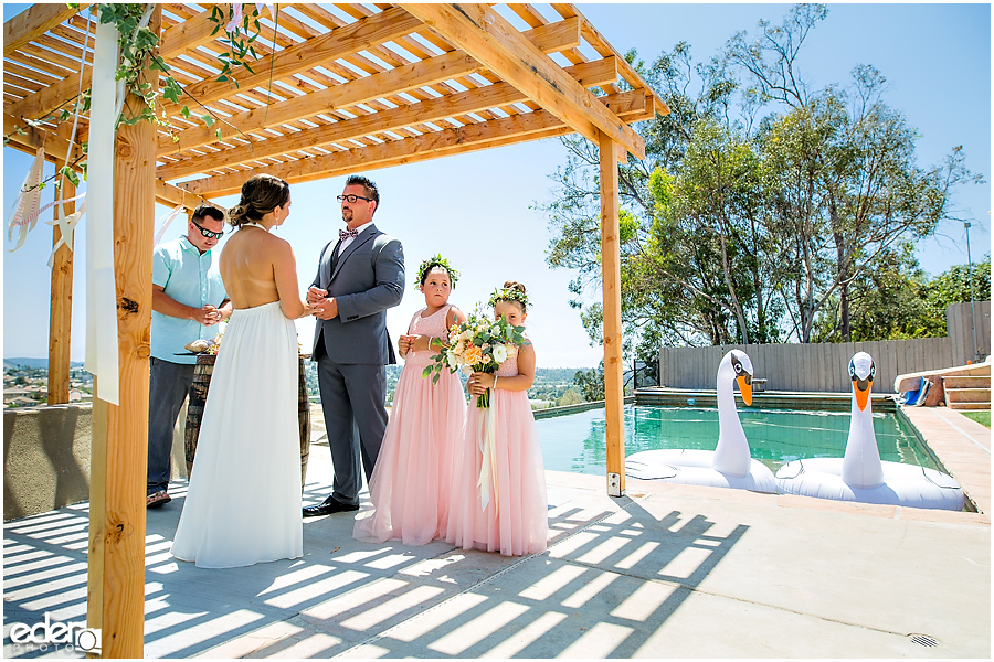 Pool wedding ceremony ring exchange.