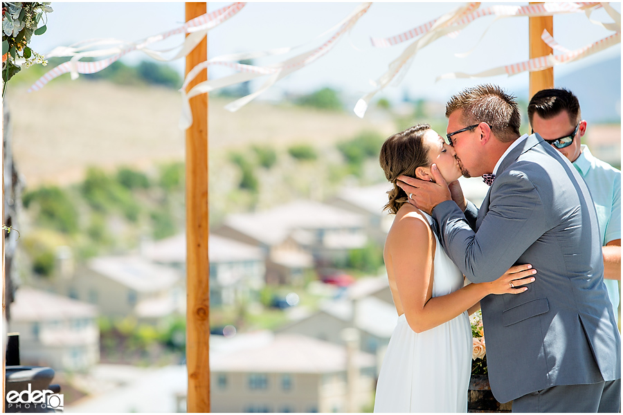 Pool wedding ceremony kiss.