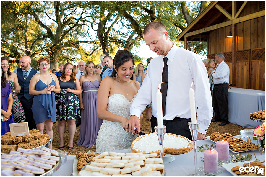 Vineyard Wedding bride and groom cookie cutting.