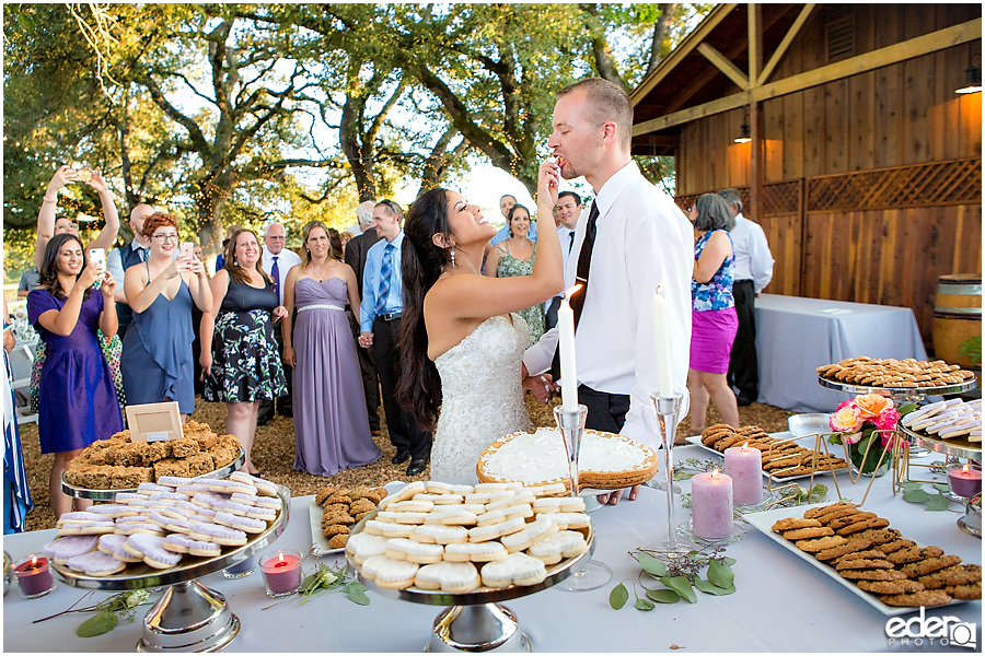 Vineyard Wedding bride and groom cookie cutting.