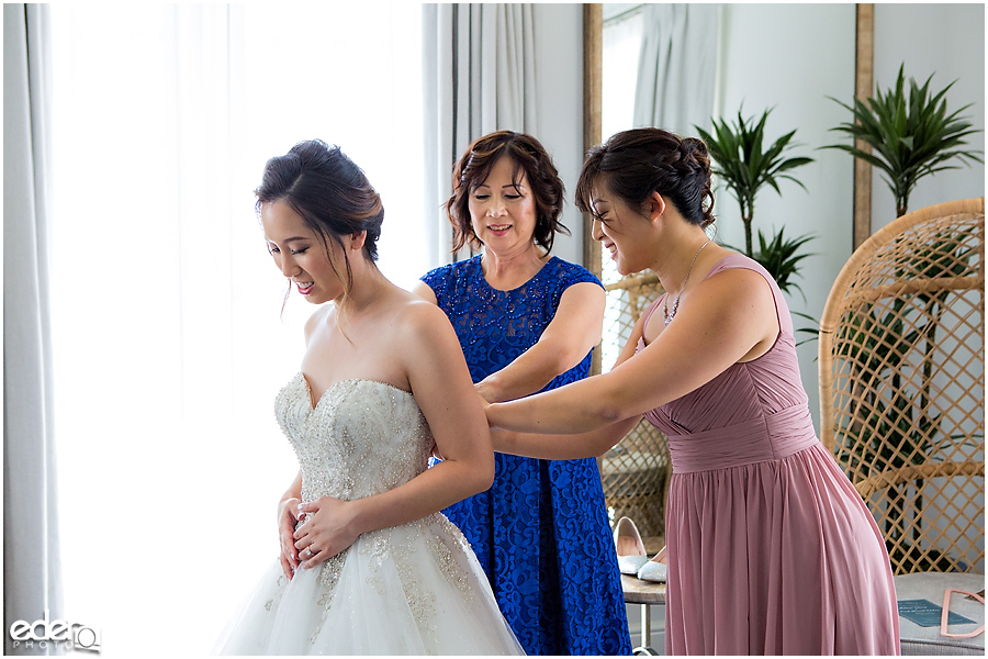 Wedding at The US Grant - photo of bride putting dress on.