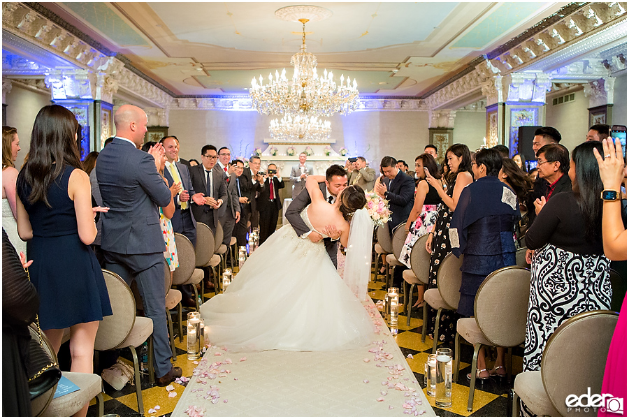 Wedding at The US Grant - photo of kiss in aisle.